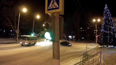 Traffic intersection with traffic lights in a winter city Stock Footage 70447485