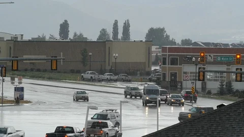 Traffic intersection in wet rain storm Video stock 105801558
