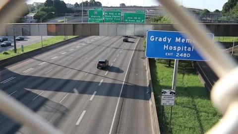Traffic on interstate 75 through a fence Downtown Atlanta Stock Footage 132811139