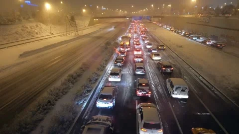 Traffic jam on A1 highway in Las Tablas, Madrid, Spain during a heavy blizzard Stock Footage 146333560