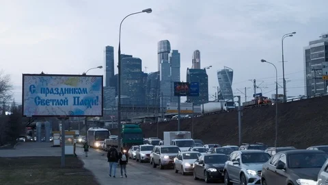 Traffic jam against the background of a billboard and skyscrapers Moscow city Stock Footage 88216539