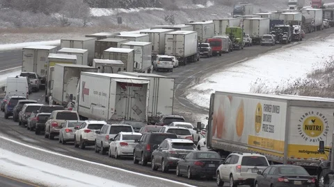 Traffic jam and gridlock on highway in winter weather snow and icy roads Stock Footage 102875429