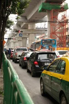 Traffic jam below construction blue line of bangkok sky train Stock Photos