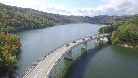 Traffic jam on bridge construction across lake in rural area, aerial view Stock Footage 146371540