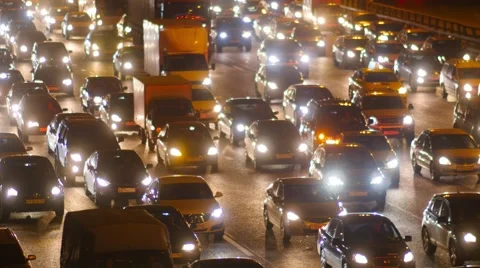 Traffic jam, dense slow flow of cars on a freeway at night. 库存影片 54057256