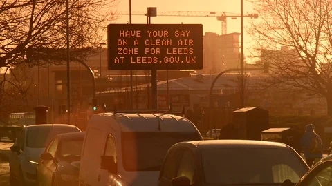 Traffic jam by digital sign asking for clean air zone for leeds uk Stock Footage 85354939
