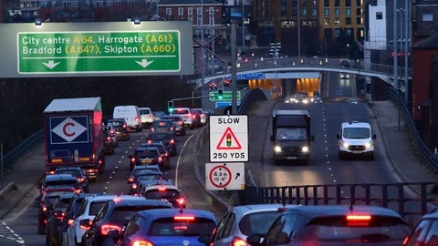 Traffic jam heading into the city centre of leeds at twilight yorkshire uk Stock Footage