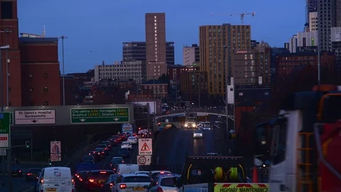 Traffic jam heading into the city centre of leeds at twilight yorkshire uk Stock Footage 122985428
