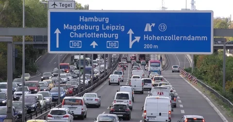 Traffic jam on highway A100 in Berlin, Germany with blue direction signs Stock Footage