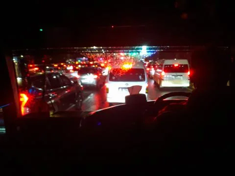 Traffic jam at night as seen from inside the bus Stock Photos