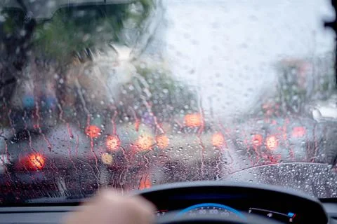 Traffic Jam with raining in evening day , focus on the rain drop of car windo Stock Photos