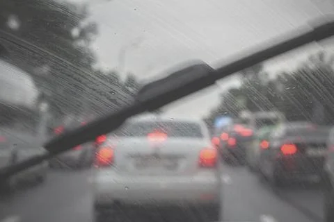 Traffic jam on a rainy day. Inside view of a car through a windshield. Raindrops Stock Photos