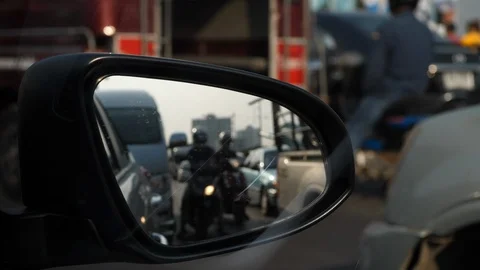 Traffic jam in rush hour of city life, focus on side mirror of vehicle car Video stock 87540467