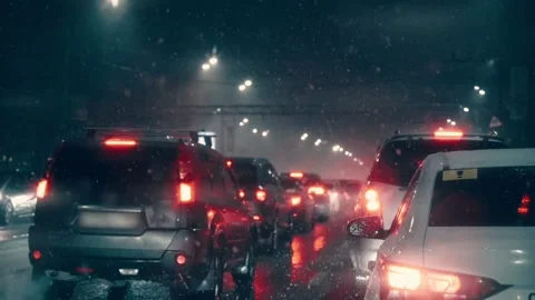 Traffic jam in rush hour. Many cars in evening or night city in snowfall. City Stock Footage 169823636