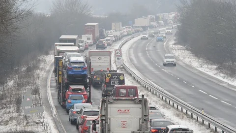 Traffic jam in winter snow on the a64 tadcaster yorkshire united kingdom Stock Footage 87829778