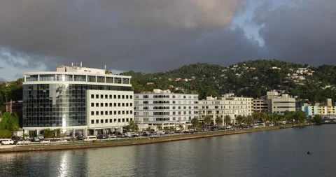 Traffic on John Compton Hwy at Castries Harbor-late sun lights buildings Stock Footage 233317285