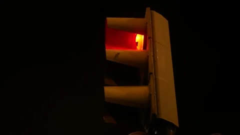 Traffic light alternating between red and green. Nighttime Stock Footage 293882582