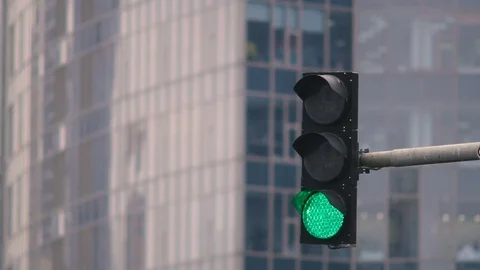 Traffic light on the background of the building. The green light is on and the Stock Footage 82170777