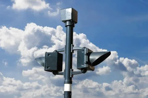 Traffic light on the background of the cloudy sky Stock Photos