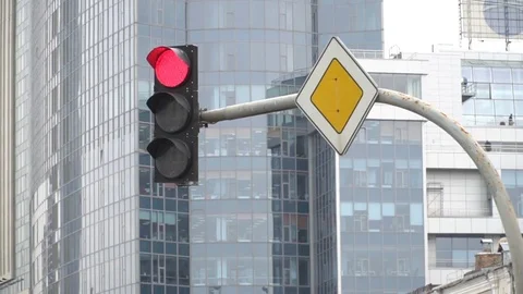 Traffic light on the background of an office building. The red light is on and Видео 82170683