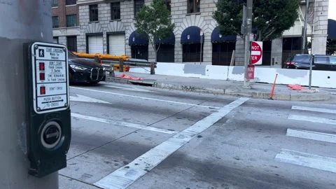 Traffic light button by road with moving cars in Downtown Stock Footage 225328628