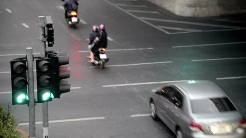 Traffic light changes from red to green against a street Stock Footage 256738803