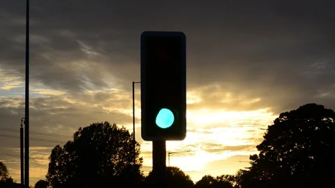 Traffic light changing from green to red at sunset united kingdom Stock Footage 95576605