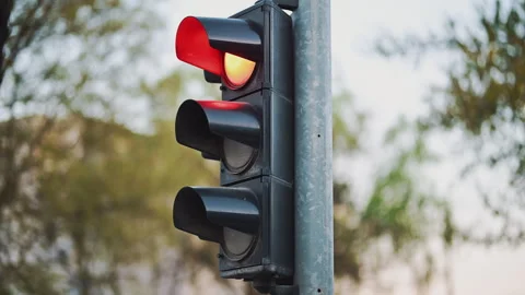 Traffic light changing from green to red, signaling stop in urban environme.. Stock Footage 333388159