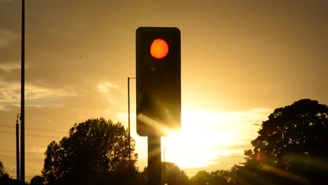 Traffic light changing from red to green at sunset united kingdom Stock Footage 95578024