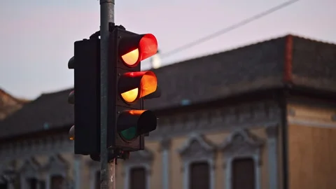 Traffic light changing from red to green, signaling stop in urban environme.. Stock Footage 332870637
