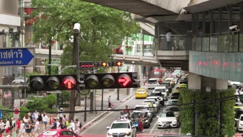 Traffic light with direction arrows on the pole over crossroad in the city Stock Footage 288952308