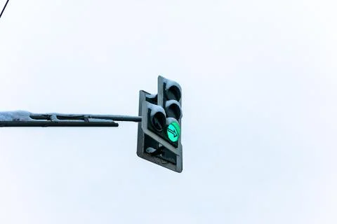 Traffic light during the day with green ON and snow Stock Photos