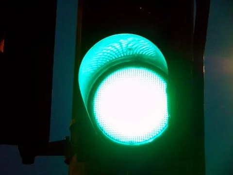 Traffic light on green in the evening Photos