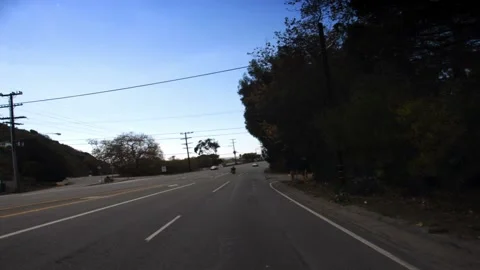 A traffic light hanging from the side of a road 스톡 동영상 157760036