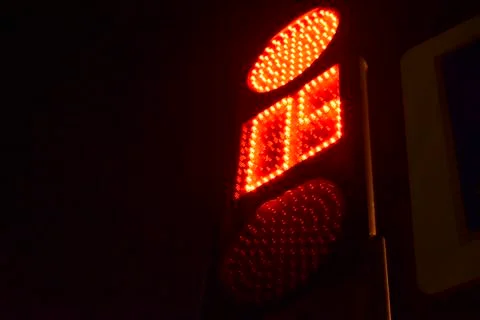 Traffic light at the intersection at night for pedestrians and cars Stock Photos