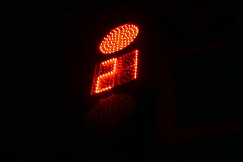 Traffic light at the intersection at night for pedestrians and cars Stock Photos