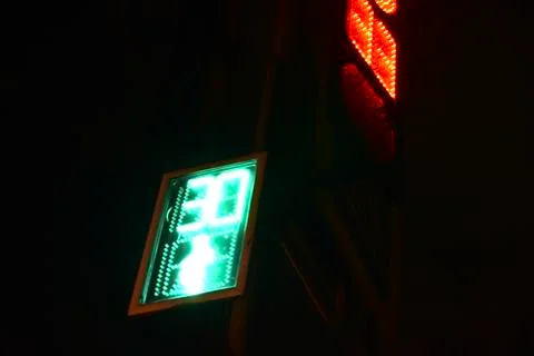 Traffic light at the intersection at night for pedestrians and cars Stock Photos