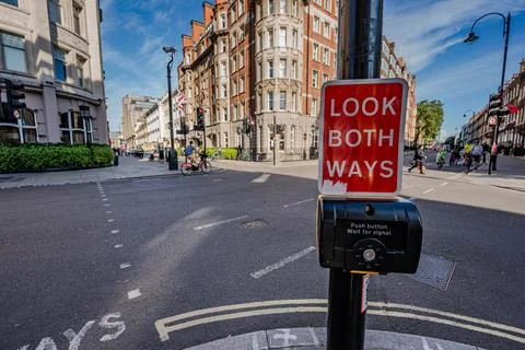 A traffic light with a push button for pedestrians to cross the street, wit.. Stock Photos