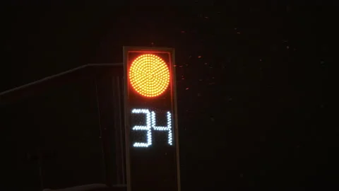 Traffic light red counting down. The night is winter it is snowing Stock Footage 166034646