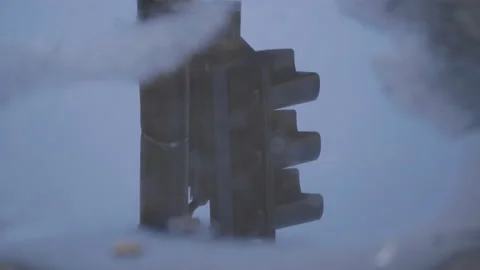 Traffic light reflection on a puddle 4K 50fps Stock Footage 238668064