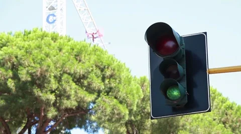 A traffic light regulating the city traffic, changing colors  Stock Footage 8564428