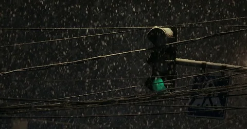Traffic light shining during snowfall. Bad weather, rain and wet snow on the Stock Footage 77694247