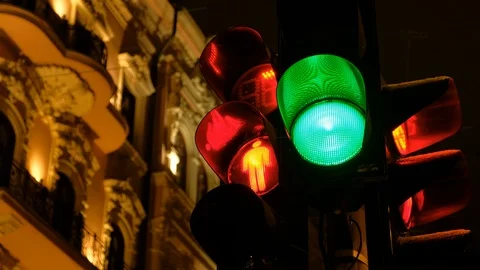 Traffic light switches from green to red in winter at night Stock Footage 101405310
