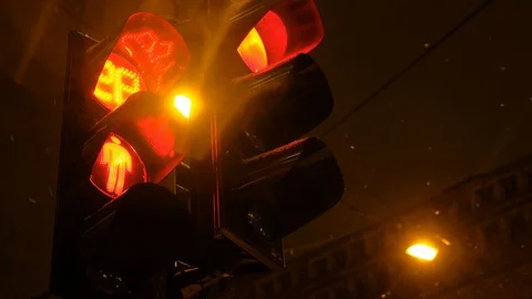 Traffic light switches from red to green in winter at night Stock Footage 101405428