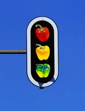 Traffic light with three bell pepper, paprika in red, yellow and green Stock Photos