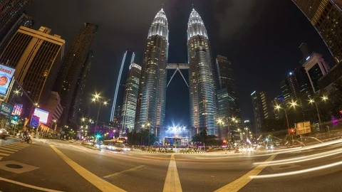 Traffic Light Trails At Intersection In Front Of Iconic Petronas Twin Tower Video stock 106762399