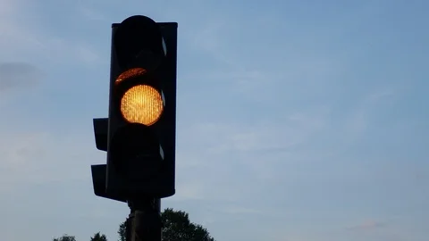 Traffic light yellow only against blue sky Stock Footage 115449358