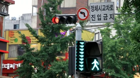 Traffic lights and crosswalk sign in downtown Seoul Stock Footage