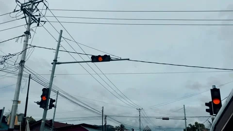 Traffic Lights and Power Lines Under Overcast Sky Stock Footage 319030276