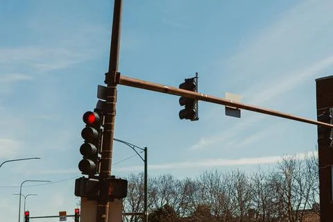 Traffic lights change at an intersection on a sunny day in a city with clea.. Stock Photos